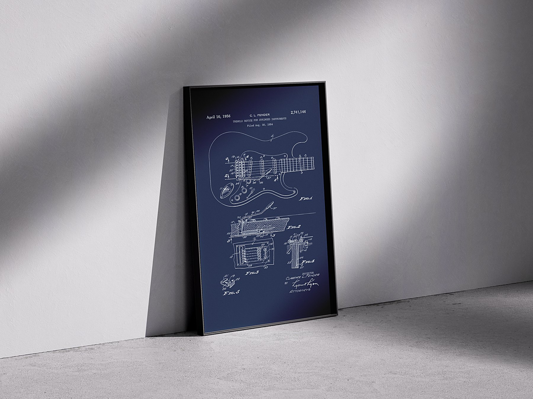 Stratocaster tremolo patent, blueprint finish, framed against a concrete wall